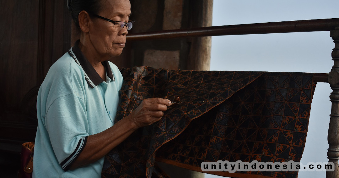 Indonesian artisan making batik fabric.